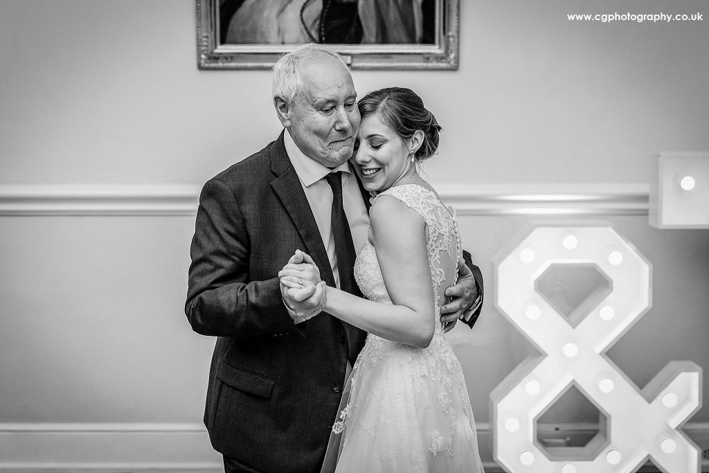 bride is dancing her first dance with her dad during her destination wedding in spain