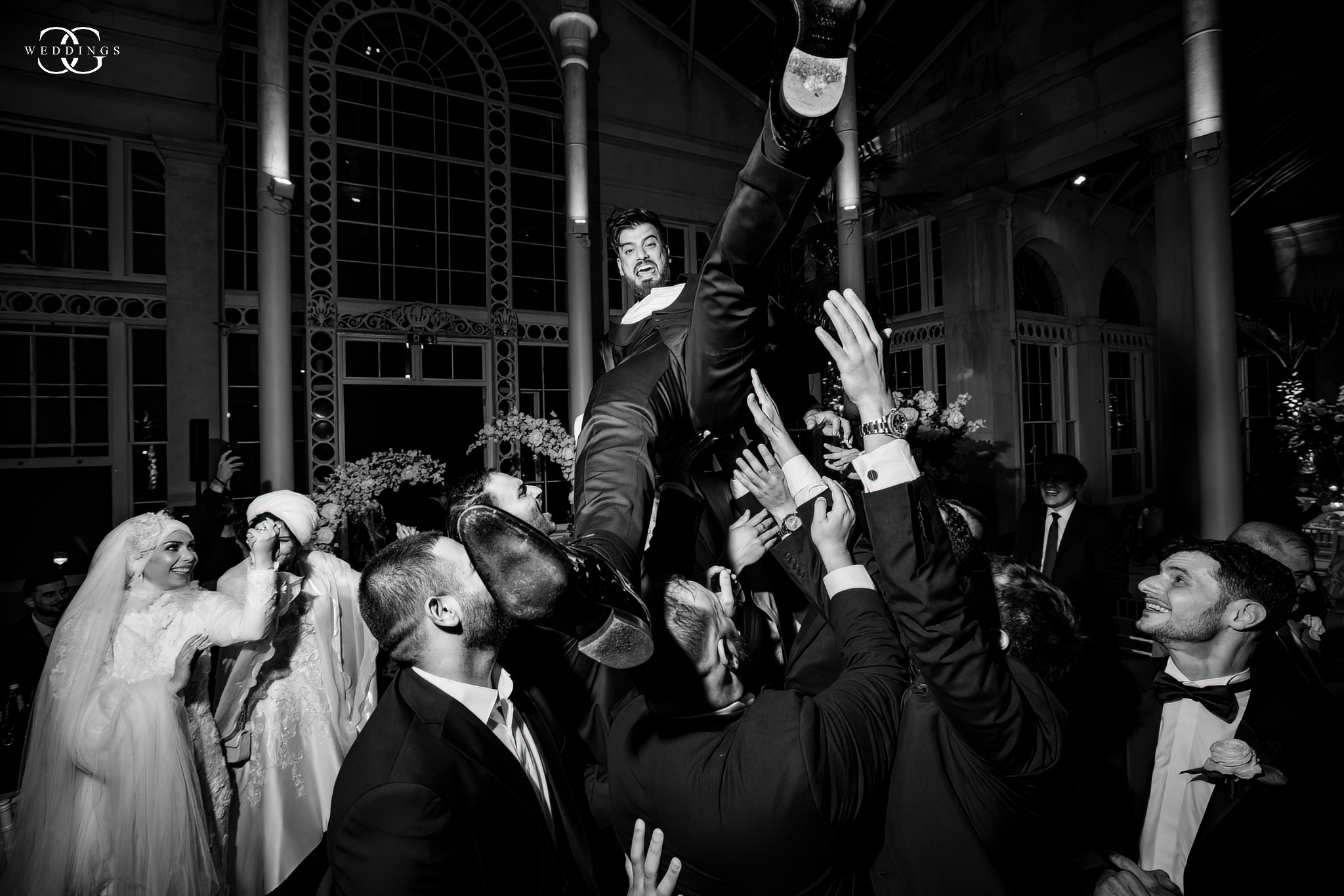 groom is being thrown up in the air on the dancefloor by his groomsman on their wedding party in Marbella