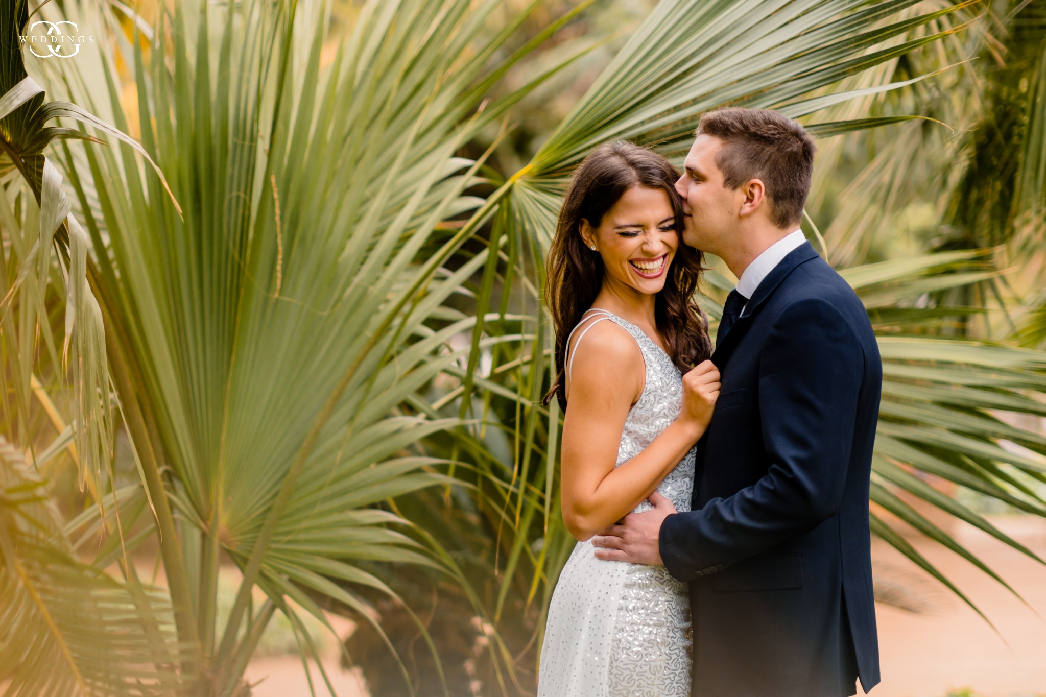 bride and groom have a huge giggle laugh during their destination wedding portrait shoot in Spain