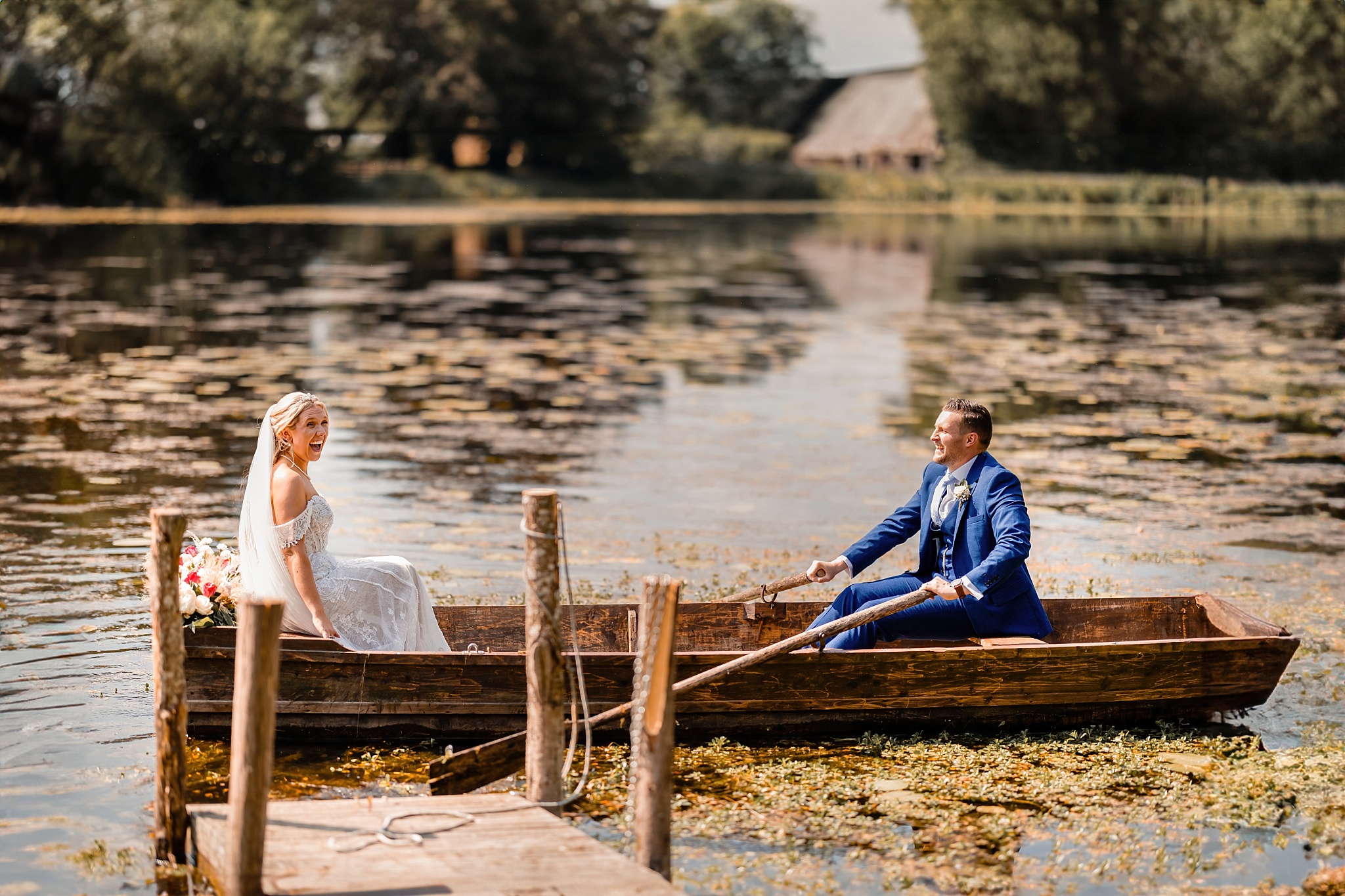 bride and groom rowing on a lake during their wedding photography session in Spain, near Marbella