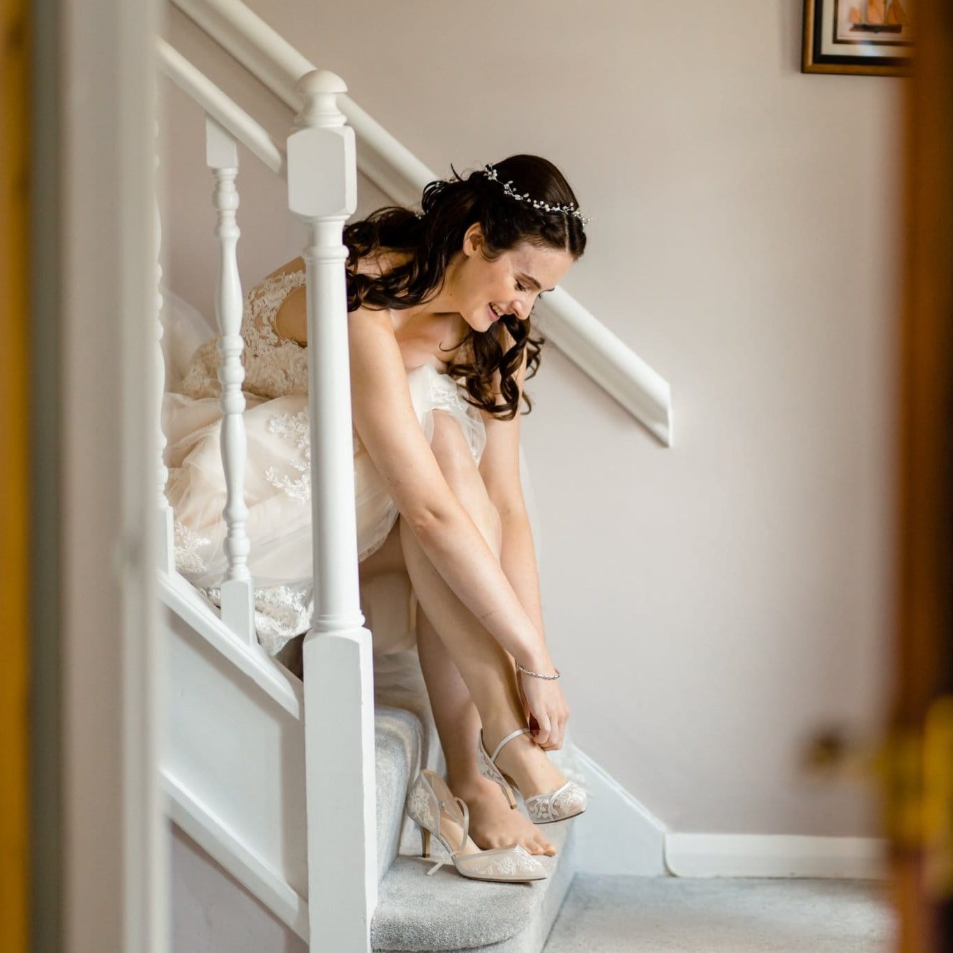 bride is putting her wedding shoes on during her santorini wedding