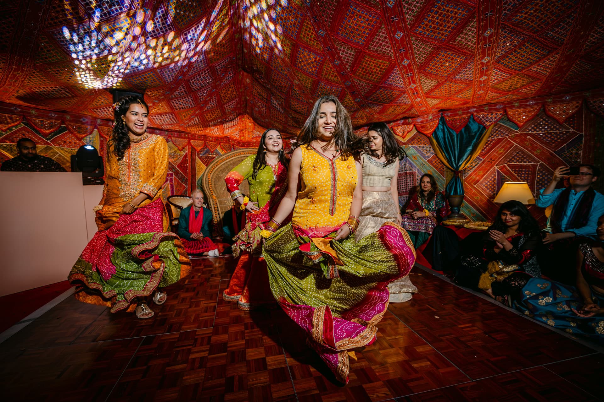 Indian Women performing traditional dance at vibrant Indian wedding celebration in Marbella