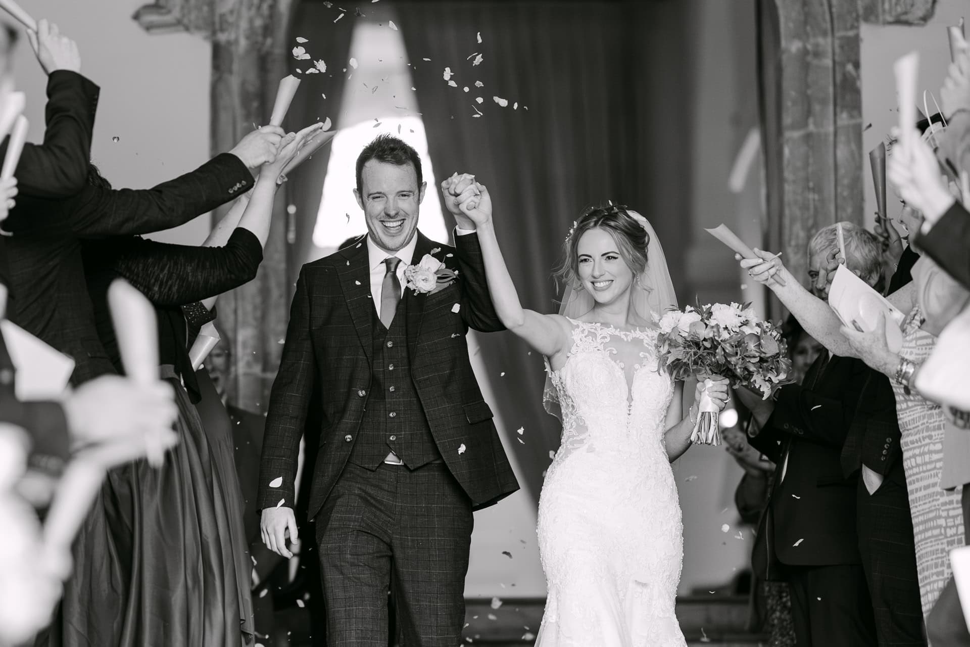 Bride and groom walking through confetti shower at their wedding photographed in marbella