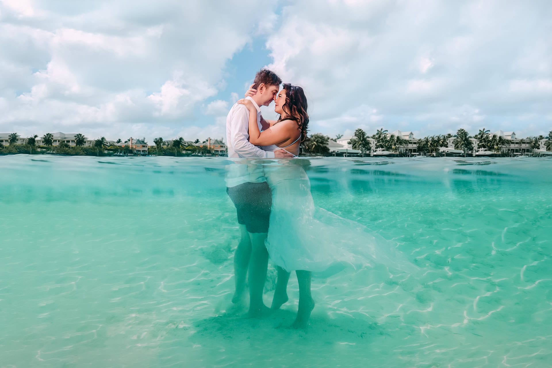 Couple embracing in shallow turquoise tropical waters