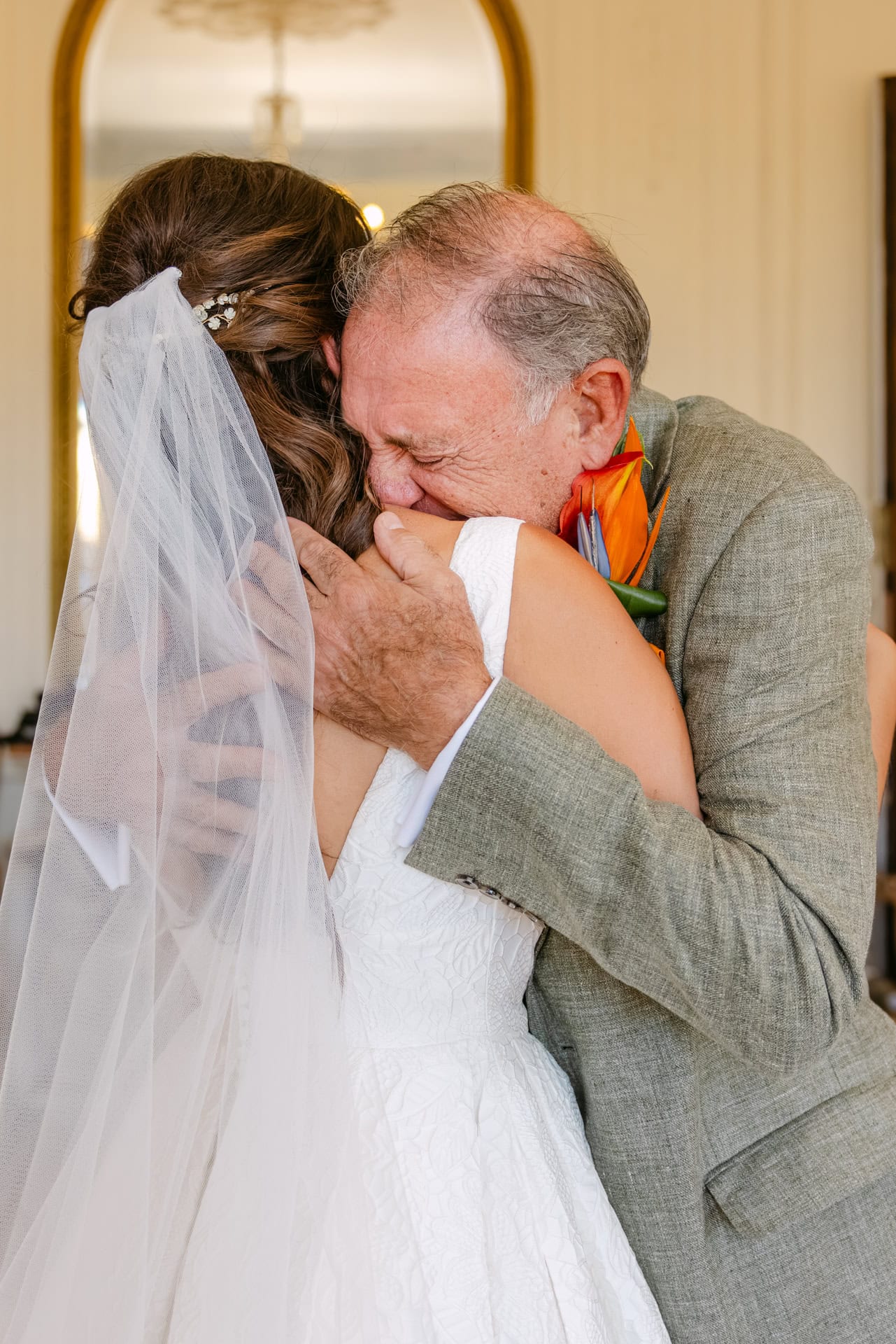 Bride hugging father during emotional wedding moment