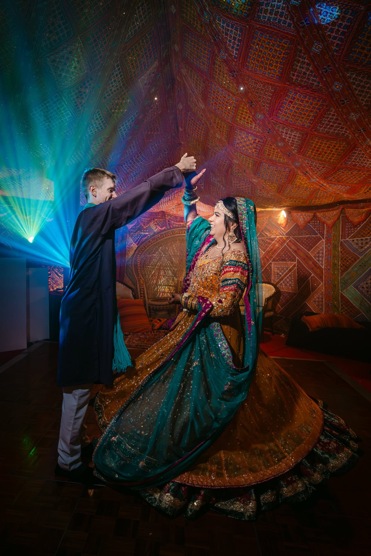 Couple dancing at colourful South Asian wedding
