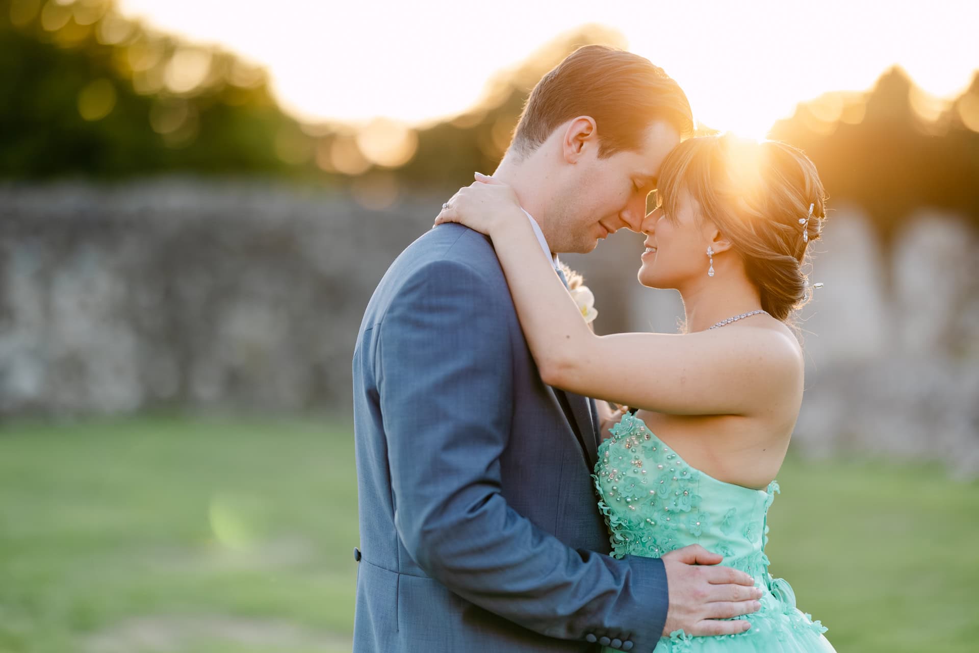 Couple embracing at sunset in formal attire