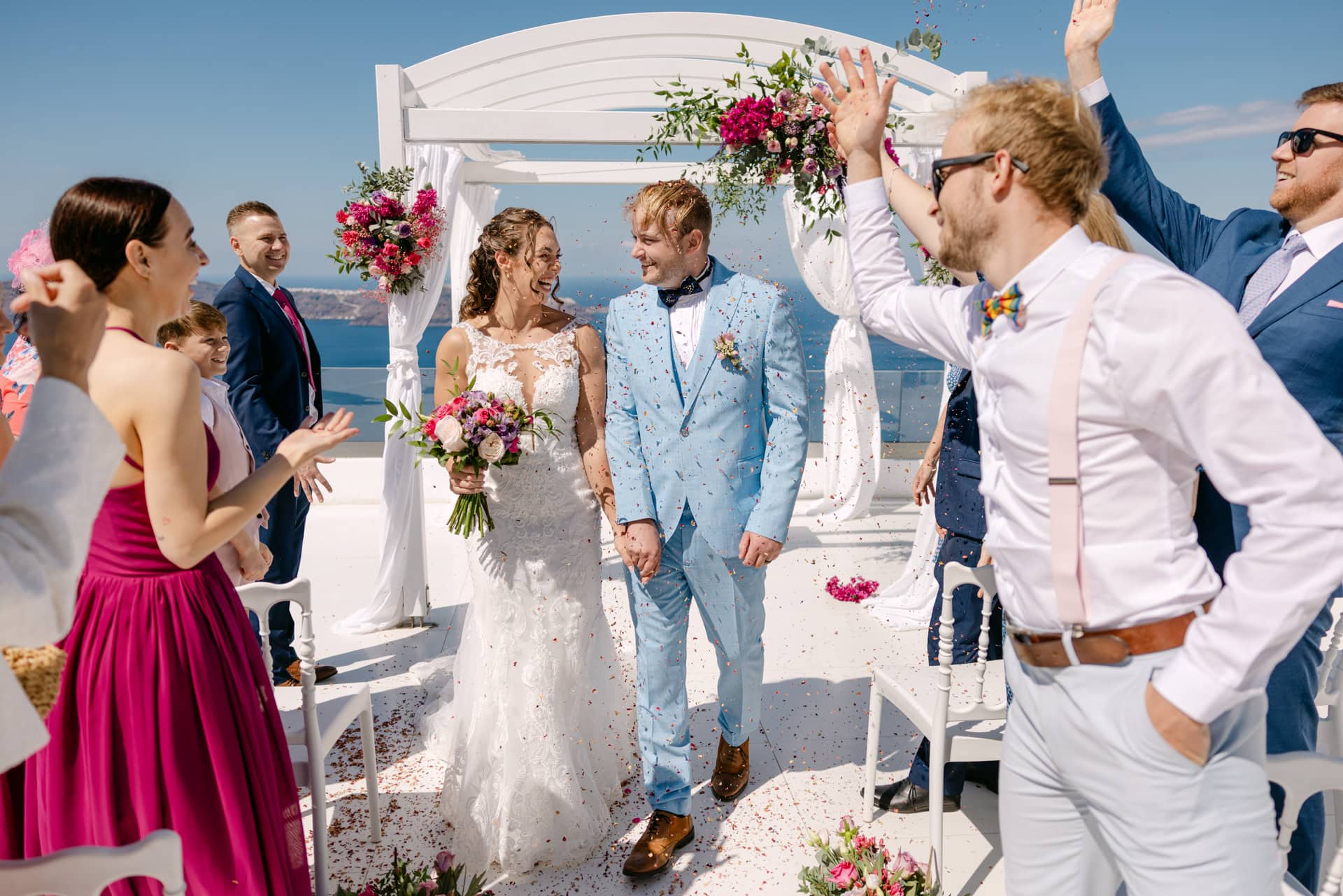Bride and groom walking through confetti outdoors