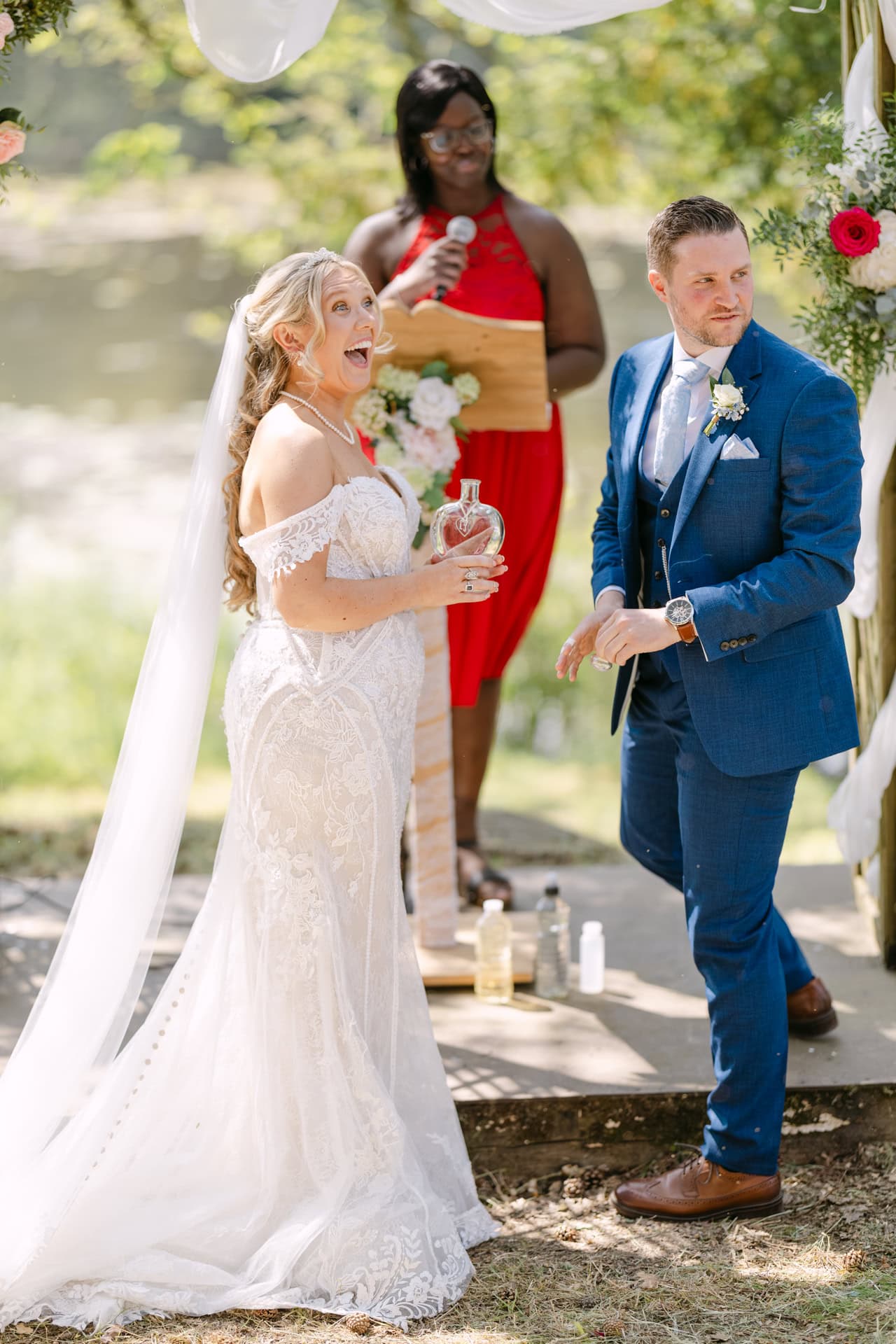 Bride and groom laughing during outdoor wedding ceremony