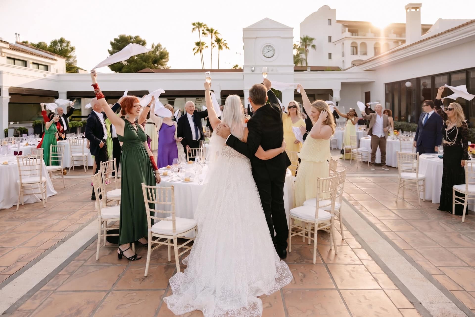 A wedding photo of Bride and groom celebrating with guests outdoors at Mariott Marbella in Westin La Quienta