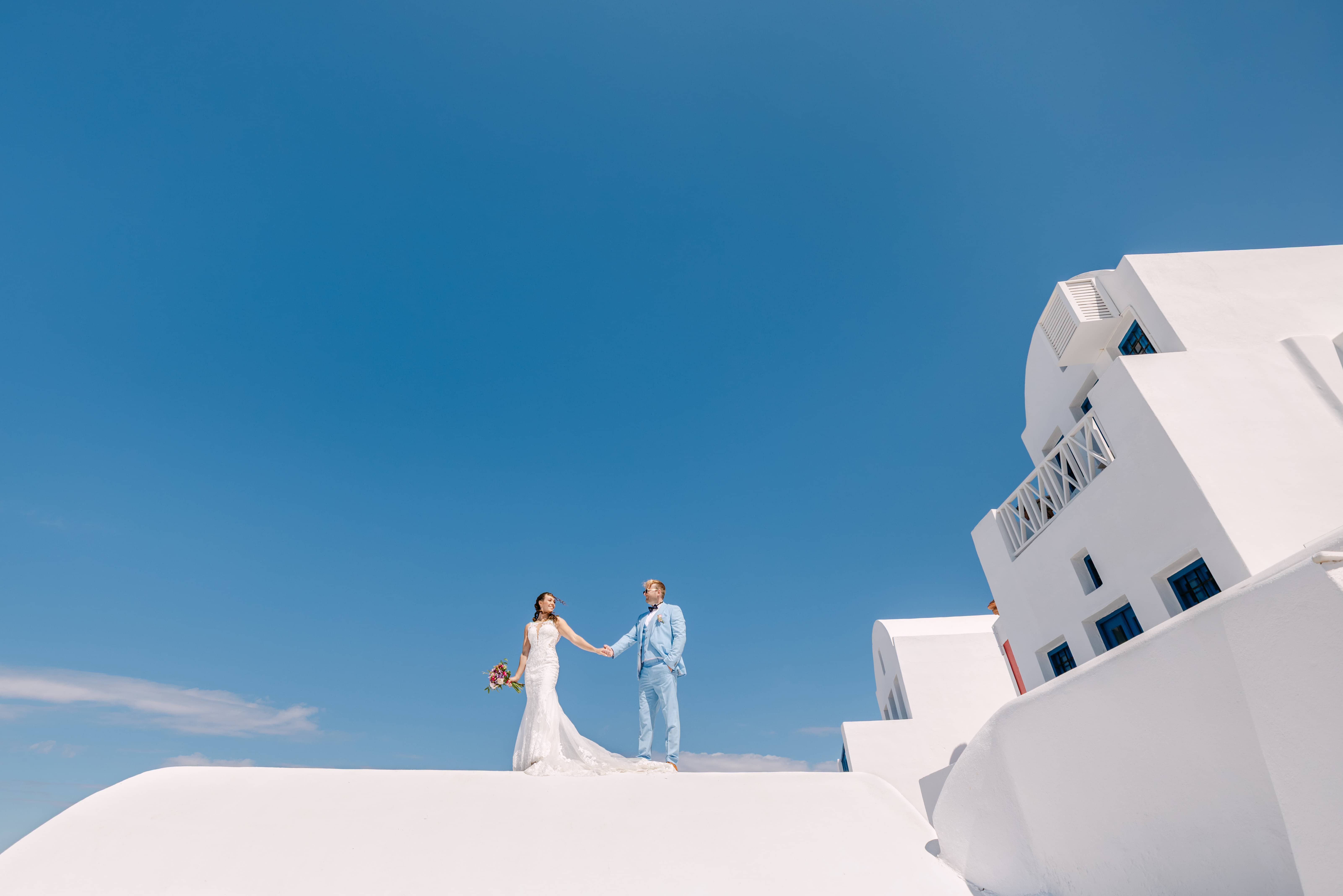 Bride and groom on white Santorini rooftop