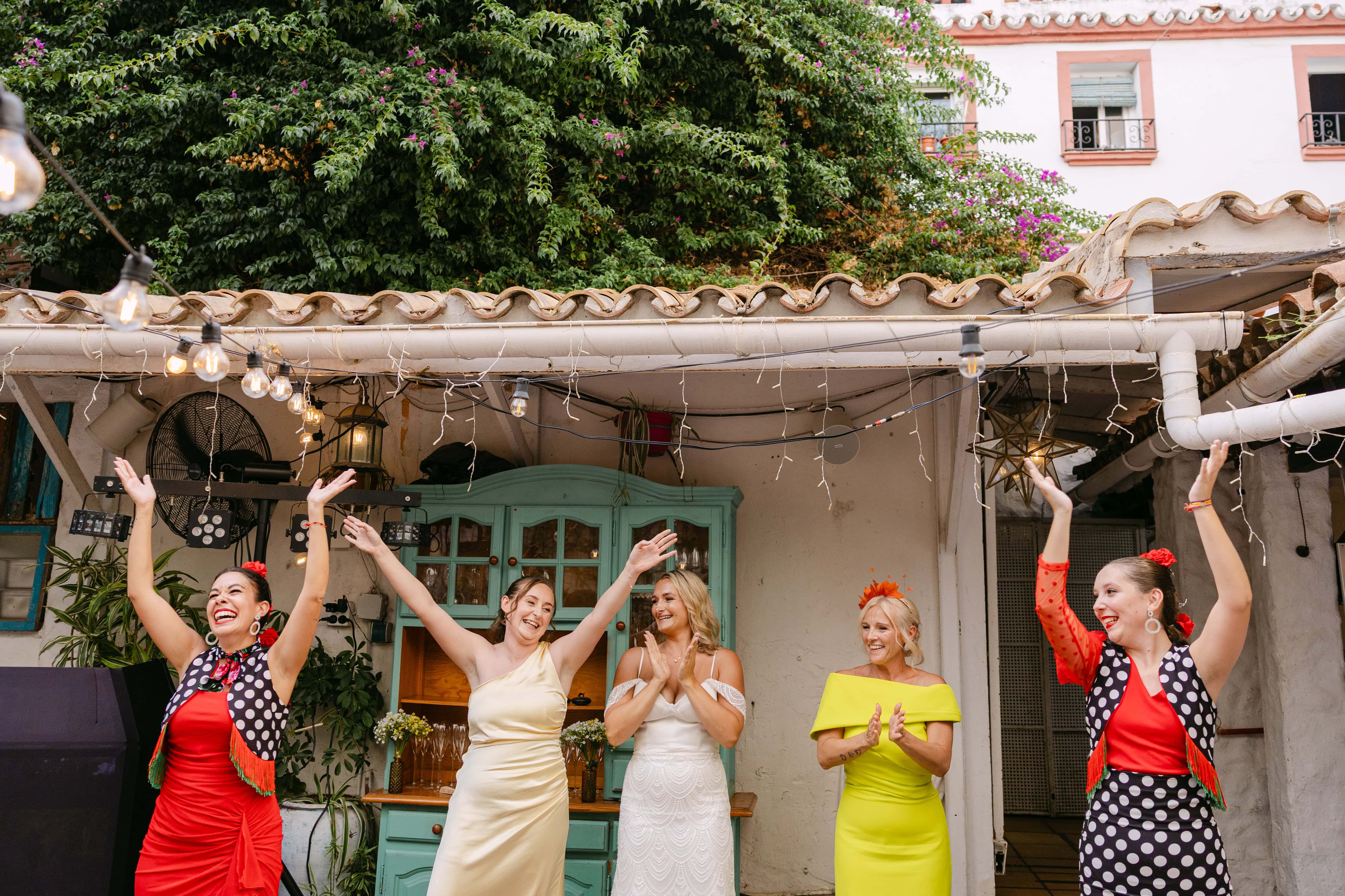 Women celebrating with flamenco dancers outdoors